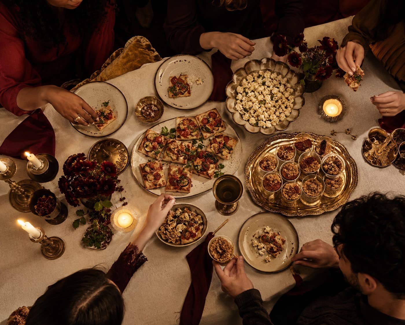 Spread of vegetable flatbread bites, herb popcorn and oat crumble cups